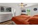 Well-lit bedroom features a queen-size bed, a dresser, a ceiling fan, and hardwood floors at 1898 9Th Ave, Deland, FL 32724