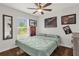 Comfortable bedroom with natural light, hardwood floors, ceiling fan, and relaxing decor at 1898 9Th Ave, Deland, FL 32724