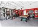 Spacious garage with pool table, weightlifting area, and a personalized, vibrant decor at 1898 9Th Ave, Deland, FL 32724