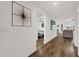 Inviting hallway with wood-look floors leads to living spaces and bedrooms with modern decor at 1898 9Th Ave, Deland, FL 32724