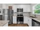 Well-equipped kitchen with modern appliances, granite countertops, and stylish white cabinetry at 1898 9Th Ave, Deland, FL 32724
