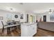 Open concept kitchen and dining area with stainless appliances, island, and view to the living room at 1898 9Th Ave, Deland, FL 32724