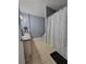 The bathroom offers a double vanity sink with tile flooring and a shower with curtain rod at 204 Terrace Ridge Cir # 204, Davenport, FL 33896