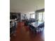 Open-concept living area featuring hardwood floors, dining area, and access to outdoor space at 204 Terrace Ridge Cir # 204, Davenport, FL 33896