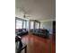 Spacious living room with hardwood floors, ceiling fan, and large windows for natural light at 204 Terrace Ridge Cir # 204, Davenport, FL 33896