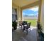 Enjoy a covered patio with peaceful backyard views from the decorative outdoor seating area at 204 Terrace Ridge Cir # 204, Davenport, FL 33896