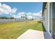 Well-maintained backyard with lush green grass and a privacy fence under a sunny sky at 2141 Rosewood Dr, Bartow, FL 33830