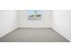 Bright bedroom with plush carpet, a window, and clean, white walls at 2141 Rosewood Dr, Bartow, FL 33830