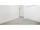 Bright bedroom with neutral walls and carpet, featuring a closet and doorway at 2141 Rosewood Dr, Bartow, FL 33830