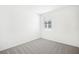 This bedroom has neutral carpet, light-colored walls, and a window for natural light at 2141 Rosewood Dr, Bartow, FL 33830