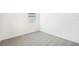 Cozy bedroom featuring plush carpet, natural light, and pristine white walls at 2141 Rosewood Dr, Bartow, FL 33830