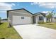 Spacious two-car garage and stone accents enhance this charming one-story home's curb appeal at 2141 Rosewood Dr, Bartow, FL 33830