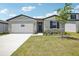 Charming one-story home with stone accents, a well-manicured lawn, and a two-car garage at 2141 Rosewood Dr, Bartow, FL 33830
