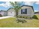 One-story home featuring stone accents, manicured landscaping and lush green lawn at 2141 Rosewood Dr, Bartow, FL 33830