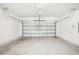 Spacious garage with concrete floor and a metal garage door at 2141 Rosewood Dr, Bartow, FL 33830