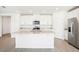 Bright, open-concept kitchen boasts an island, stainless steel appliances, and ample counter space at 2141 Rosewood Dr, Bartow, FL 33830