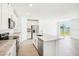 Modern kitchen with stainless steel appliances, stone countertops and center island with breakfast bar at 2141 Rosewood Dr, Bartow, FL 33830