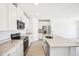 Modern kitchen with stainless steel appliances, stone countertops and center island with breakfast bar at 2141 Rosewood Dr, Bartow, FL 33830
