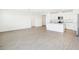 Open-concept living area with modern kitchen, stainless appliances, and light wood-look flooring at 2141 Rosewood Dr, Bartow, FL 33830