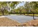 Outdoor basketball court with well-maintained surface and hoops surrounded by trees and greenery at 2327 Fieldingwood Rd, Maitland, FL 32751