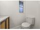 This powder room features a modern toilet, vanity, and sink with a window at 2327 Fieldingwood Rd, Maitland, FL 32751
