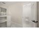 Bathroom with a tiled shower stall featuring built-in shelving and a toilet in a separate room at 2327 Fieldingwood Rd, Maitland, FL 32751