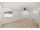 Bright bedroom with light wood floors, white walls, a window, a ceiling fan, and two closets at 2327 Fieldingwood Rd, Maitland, FL 32751