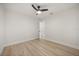 Bright bedroom with light wood floors, white walls, and ceiling fan at 2327 Fieldingwood Rd, Maitland, FL 32751