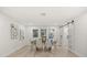 Dining room with light wood floors and sliding barn doors at 2327 Fieldingwood Rd, Maitland, FL 32751