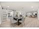 Open concept dining room featuring wood-look floors and a barn door leading to an office at 2327 Fieldingwood Rd, Maitland, FL 32751