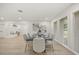 Bright dining room featuring a table set for six and large windows for ample natural light at 2327 Fieldingwood Rd, Maitland, FL 32751