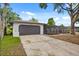 Charming single-story home featuring a large garage, screened patio, and well-maintained landscaping at 2327 Fieldingwood Rd, Maitland, FL 32751