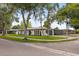 Corner lot showcasing a charming single-story home with arched windows and a lush green lawn at 2327 Fieldingwood Rd, Maitland, FL 32751