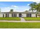 Stunning single story home featuring an arched doorway and manicured front yard landscaping at 2327 Fieldingwood Rd, Maitland, FL 32751