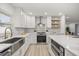 Bright kitchen featuring quartz countertops, stainless steel appliances, wood look tile and a farmhouse sink at 2327 Fieldingwood Rd, Maitland, FL 32751