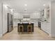 Bright kitchen with a center island, pendant lights, stainless steel appliances, and shaker cabinets at 2327 Fieldingwood Rd, Maitland, FL 32751