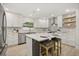 Beautiful kitchen featuring stainless steel appliances, a center island, and wood open shelving at 2327 Fieldingwood Rd, Maitland, FL 32751