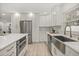 Spacious kitchen with quartz countertops, stainless steel appliances, wood look tile and a farmhouse sink at 2327 Fieldingwood Rd, Maitland, FL 32751