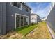 An angled view of the backyard with an artificial turf lawn at 242 Coco Plum Dr, Davenport, FL 33897