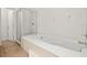 This bathroom boasts a large soaking tub, glass shower and tile flooring at 242 Coco Plum Dr, Davenport, FL 33897