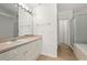 This bathroom features a sink with a large vanity, a glass shower, and a door to a closet at 242 Coco Plum Dr, Davenport, FL 33897