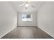Bright bedroom with modern light gray flooring, ceiling fan, and window offering natural light at 242 Coco Plum Dr, Davenport, FL 33897