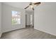 Bedroom with laminate floors, a ceiling fan, a large window and an interior door leading to another room at 242 Coco Plum Dr, Davenport, FL 33897