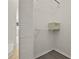 Walk-in closet featuring white wood slat doors and a safe on an upper shelf at 242 Coco Plum Dr, Davenport, FL 33897