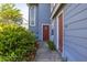 Inviting townhouse entrance with vibrant greenery, a walkway, and a cozy, welcoming feel at 242 Coco Plum Dr, Davenport, FL 33897