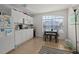Bright kitchen with white cabinets, a microwave, tile flooring, and a dining table at 242 Coco Plum Dr, Davenport, FL 33897
