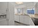 Kitchen featuring white appliances, cabinets, and laminate countertops at 242 Coco Plum Dr, Davenport, FL 33897