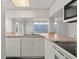 Bright kitchen featuring white cabinets and appliances at 242 Coco Plum Dr, Davenport, FL 33897