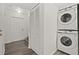 Convenient hallway with stacked washer and dryer set, storage closet, and access to stairs at 242 Coco Plum Dr, Davenport, FL 33897