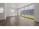 Open living area features wood floors, large sliding glass doors, and bright sunlight at 242 Coco Plum Dr, Davenport, FL 33897